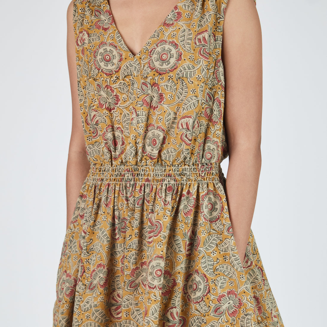Woman wearing a floral patterned dress on a white background