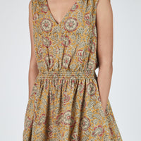 Woman wearing a floral patterned dress on a white background
